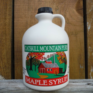 plastic jug of maple syrup with Catskill Mountain Maple Maple Syrup on the label and a farm scene