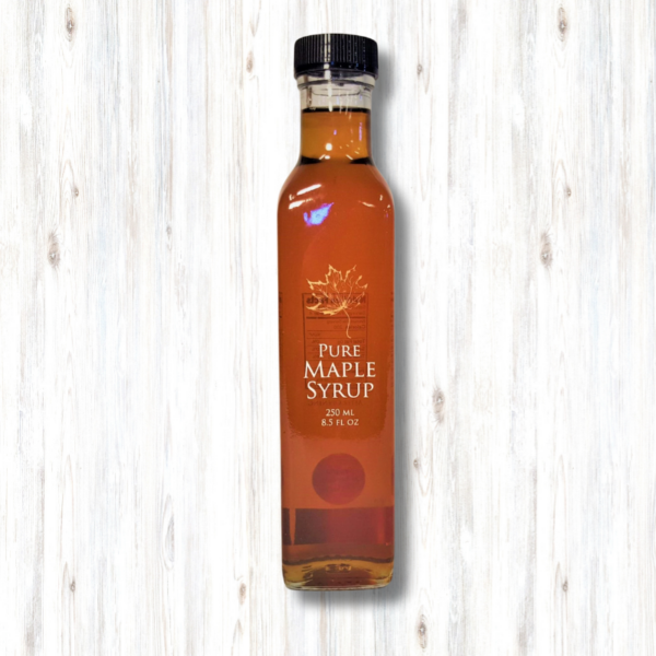 maple syrup in a tall glass bottle with a gold maple leaf